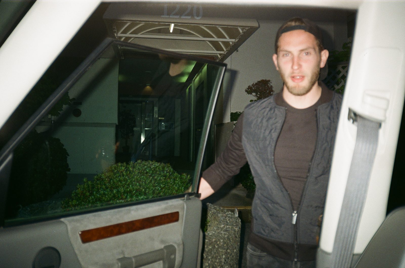 Figure by car at night