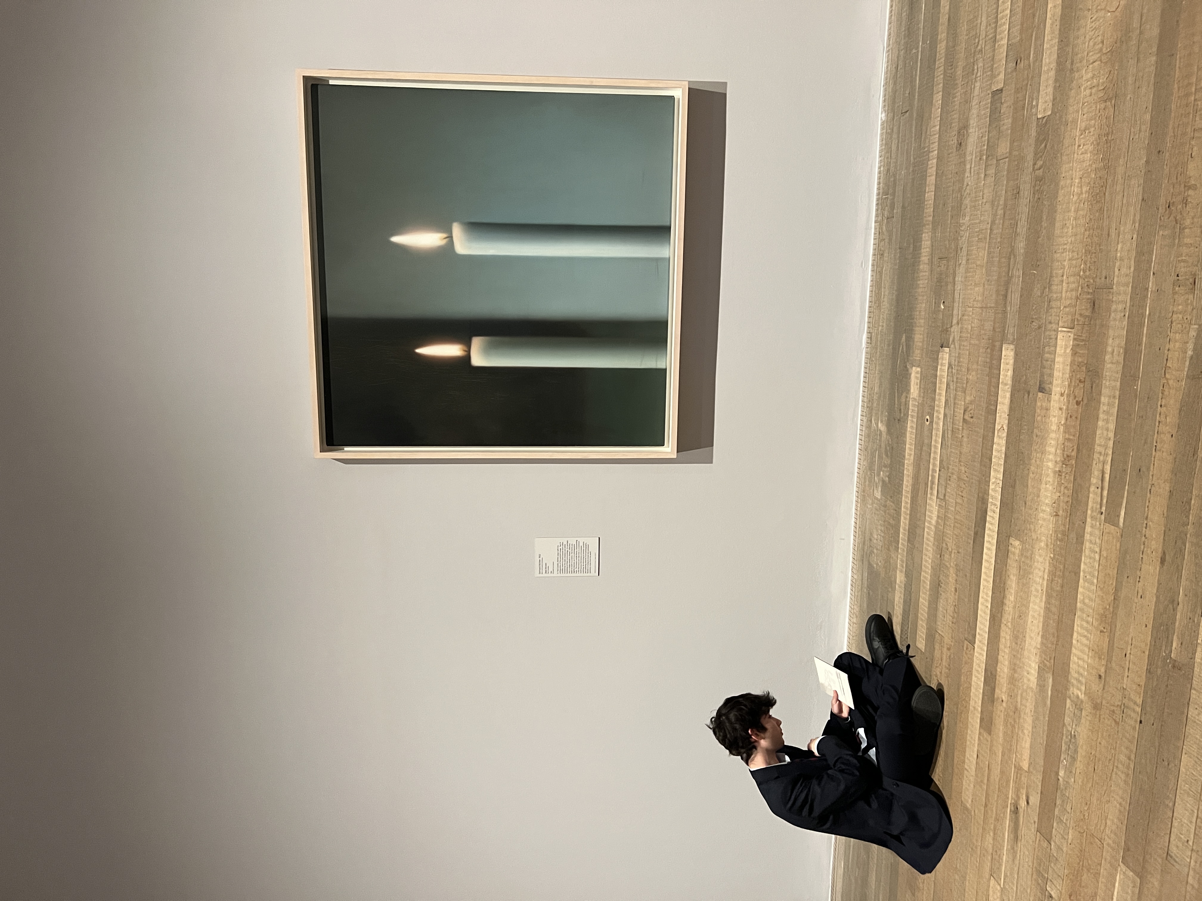 Figure reading on gallery floor